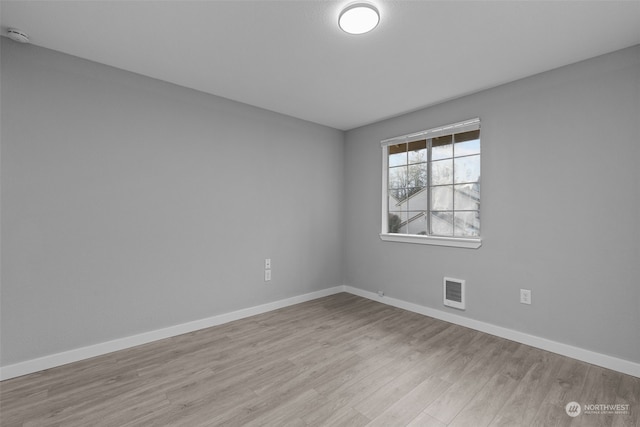 spare room with light hardwood / wood-style floors