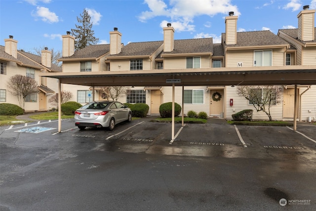 view of parking / parking lot featuring a carport