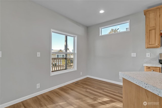 unfurnished dining area with light hardwood / wood-style flooring