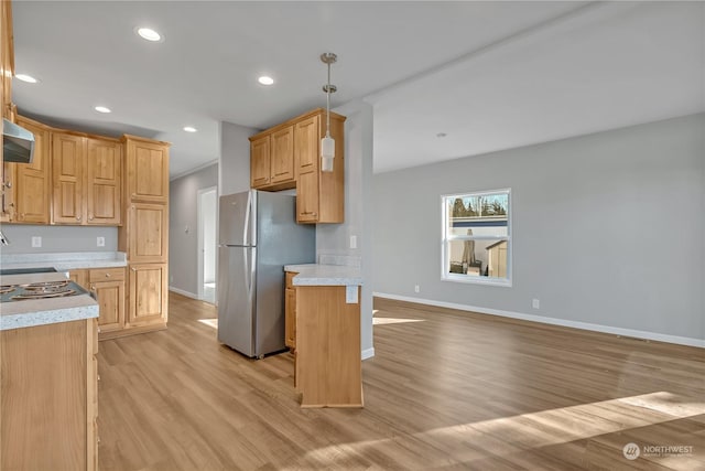 kitchen with decorative light fixtures, light hardwood / wood-style flooring, and stainless steel fridge