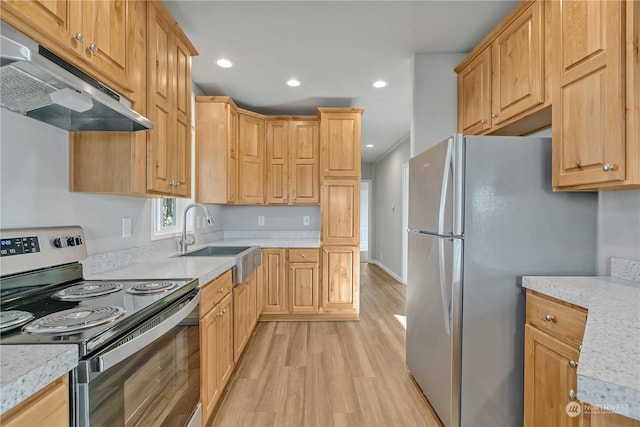 kitchen featuring appliances with stainless steel finishes, light hardwood / wood-style floors, sink, and light brown cabinets