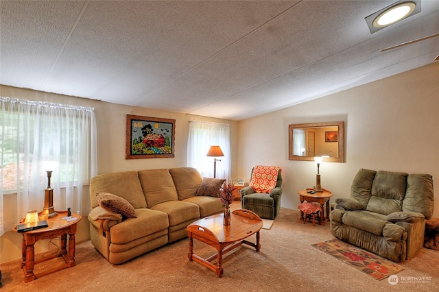 carpeted living room featuring vaulted ceiling and a textured ceiling