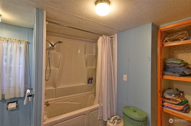 bathroom with a textured ceiling and shower / bath combo with shower curtain