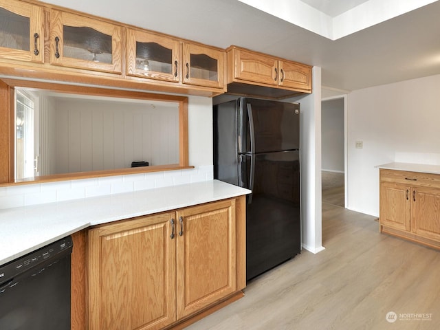 kitchen featuring light hardwood / wood-style floors and black appliances