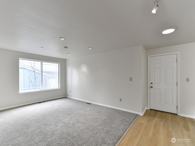 empty room with light colored carpet