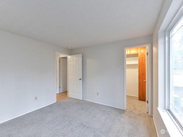 carpeted spare room with a textured ceiling