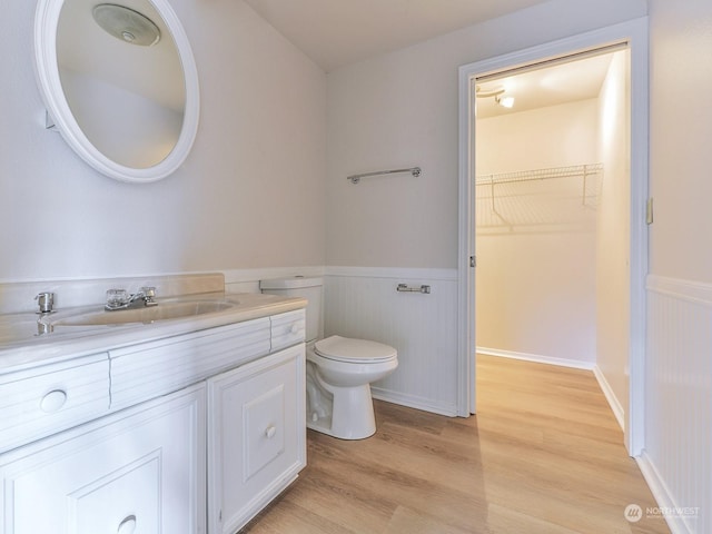 bathroom featuring vanity, hardwood / wood-style flooring, and toilet