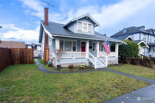 bungalow featuring a porch and a front yard