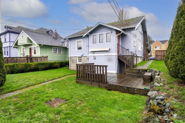 back of house with a wooden deck and a yard