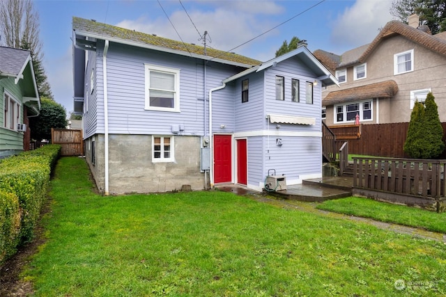 back of house featuring a yard