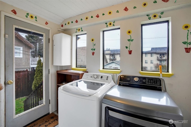 laundry area with wooden ceiling and washer and dryer