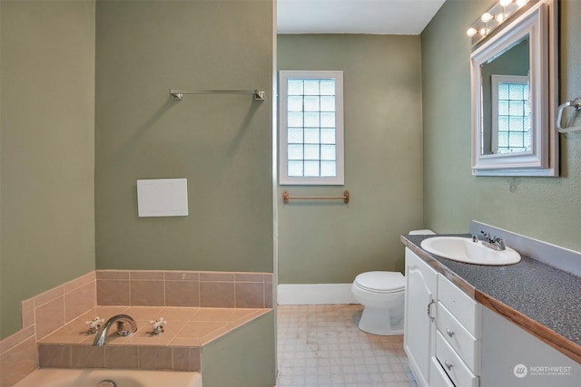 bathroom featuring vanity, a washtub, plenty of natural light, and toilet