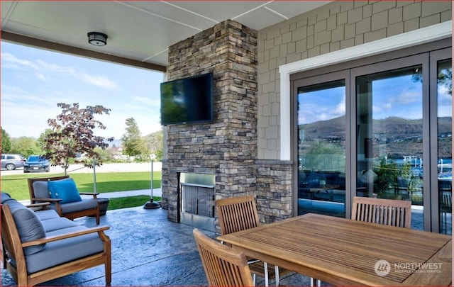 view of patio / terrace featuring an outdoor stone fireplace