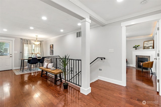 hall with dark wood-type flooring and crown molding