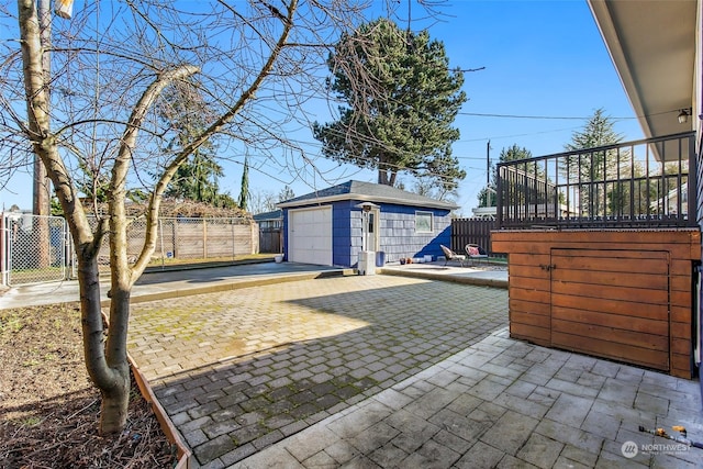 view of patio / terrace with a garage and an outdoor structure