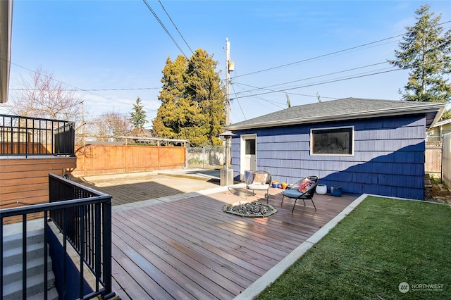 wooden terrace featuring a lawn