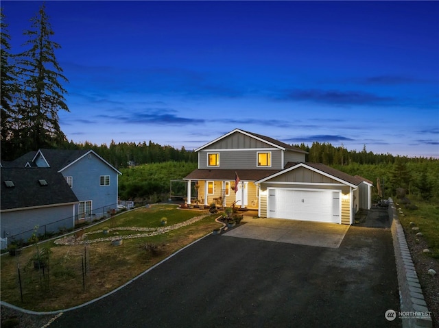 view of front of property with a garage and a yard