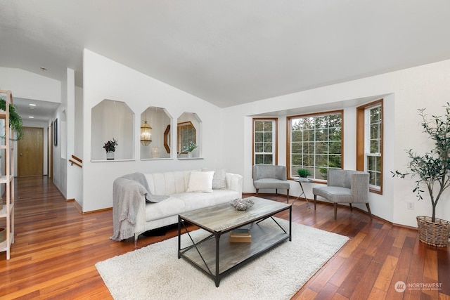 living room featuring hardwood / wood-style flooring and vaulted ceiling