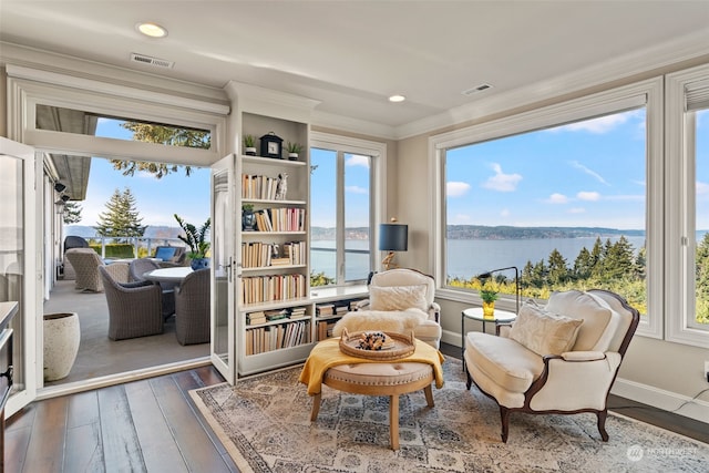 sunroom / solarium with a water view