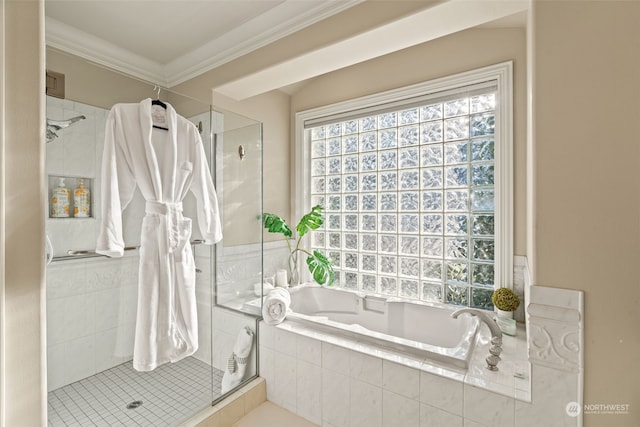 bathroom with ornamental molding and separate shower and tub