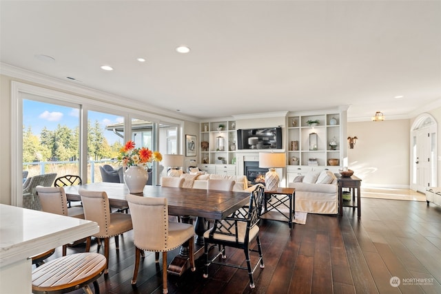 dining space with dark hardwood / wood-style flooring and ornamental molding