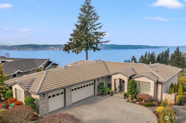 view of front facade with a garage and a water view