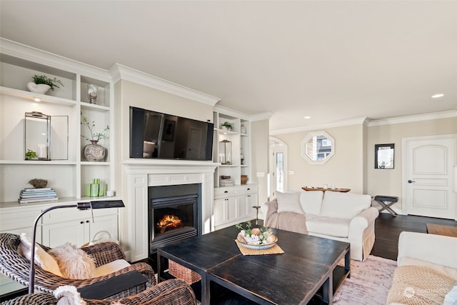 living room featuring crown molding, built in shelves, and hardwood / wood-style floors