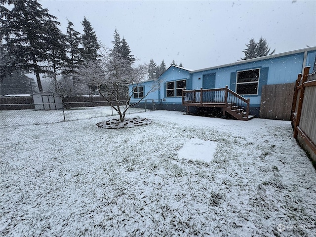 snowy yard featuring a deck