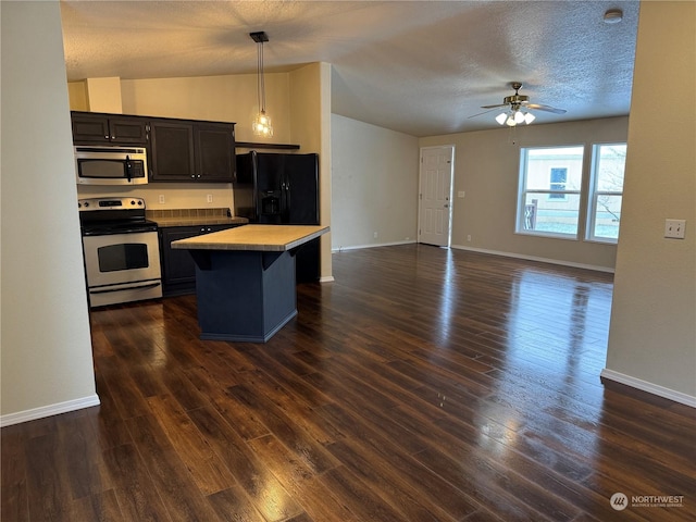 kitchen with butcher block counters, a center island, appliances with stainless steel finishes, dark hardwood / wood-style floors, and pendant lighting