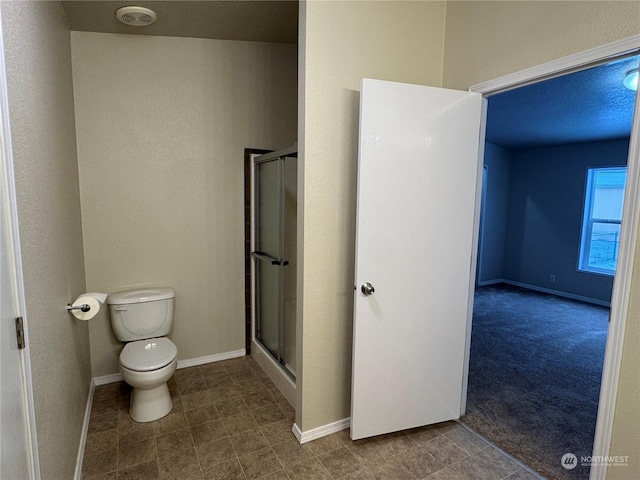 bathroom with walk in shower and toilet