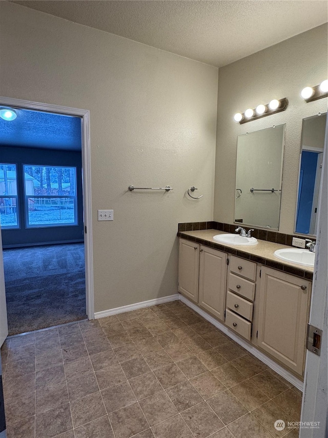 bathroom with vanity and a textured ceiling