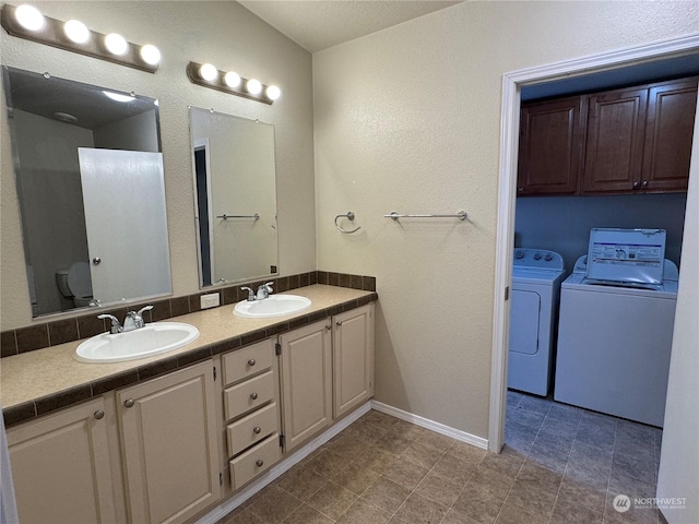 bathroom with vanity, independent washer and dryer, and toilet