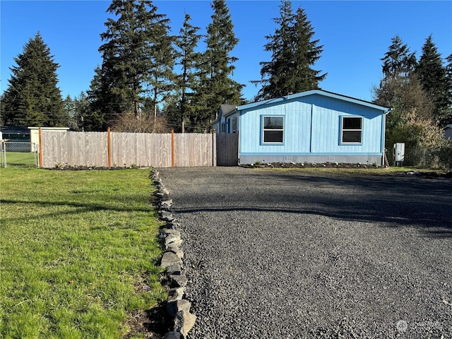 view of side of property with a yard