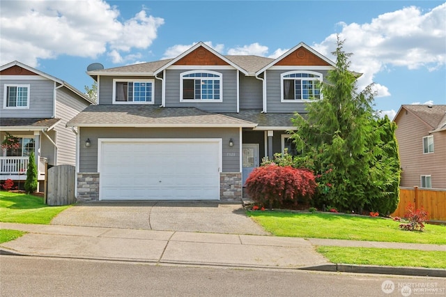 craftsman-style home featuring a garage and a front lawn