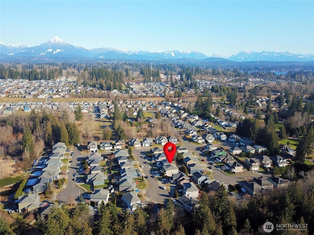 birds eye view of property with a mountain view