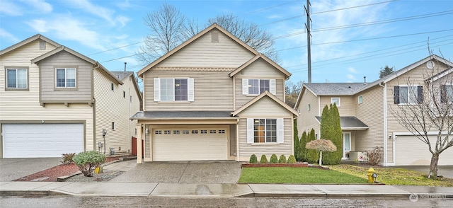 view of front of property with a garage and a front lawn