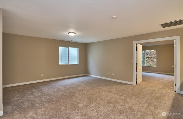 carpeted spare room with a healthy amount of sunlight