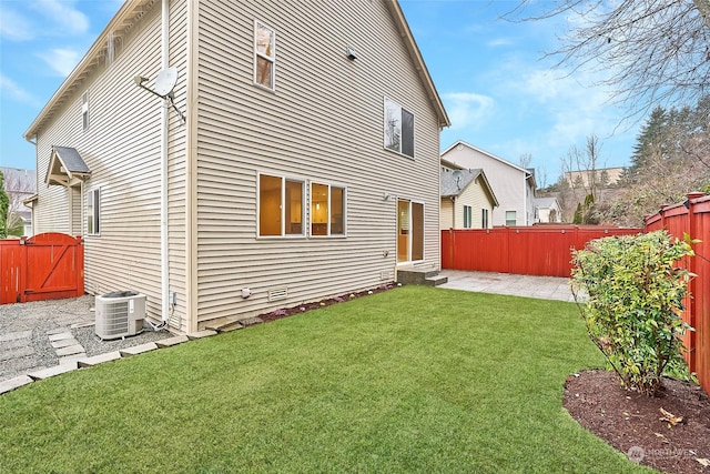 rear view of house with a yard, a patio area, and central air condition unit