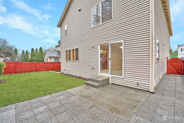 rear view of house with a yard and a patio