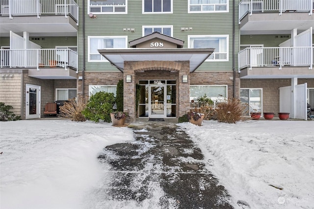 view of snow covered property entrance