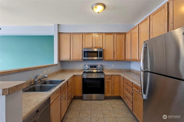 kitchen featuring stainless steel appliances, light tile patterned flooring, and sink