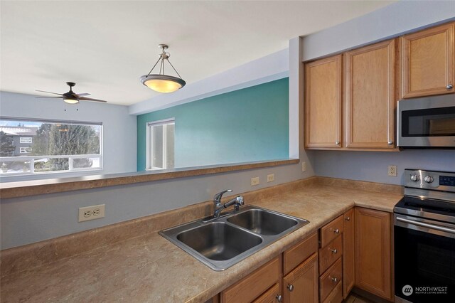 kitchen with stainless steel appliances, sink, pendant lighting, and ceiling fan