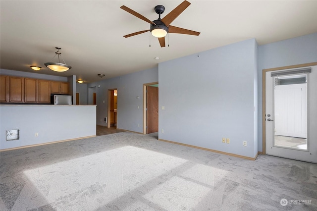 unfurnished living room with ceiling fan and light colored carpet