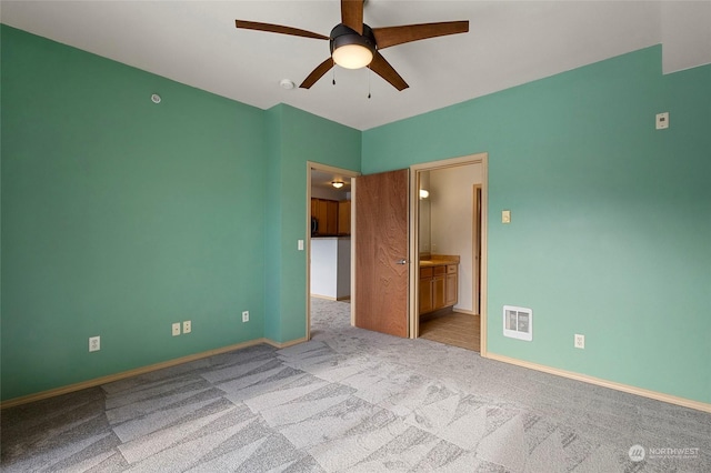 carpeted empty room featuring ceiling fan