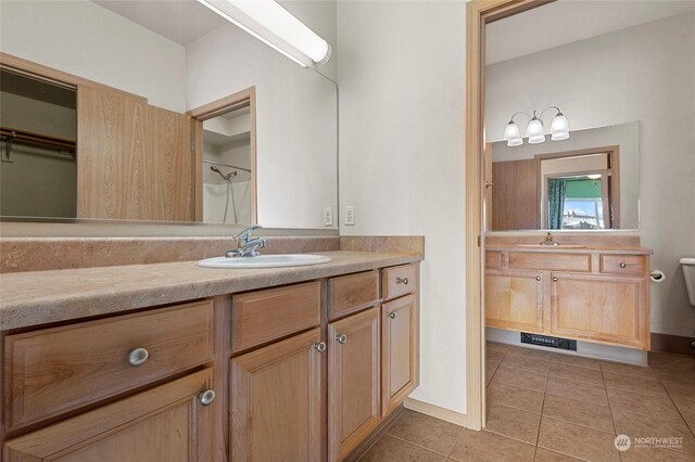 bathroom featuring tile patterned floors, toilet, and vanity