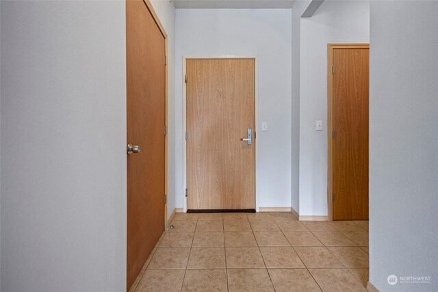 hallway featuring light tile patterned flooring