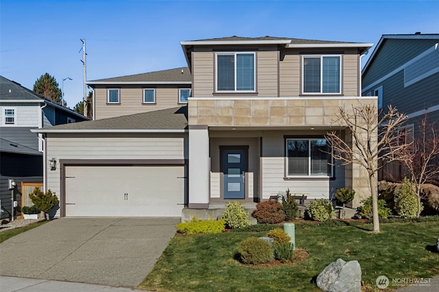 front of property featuring a garage and a front yard