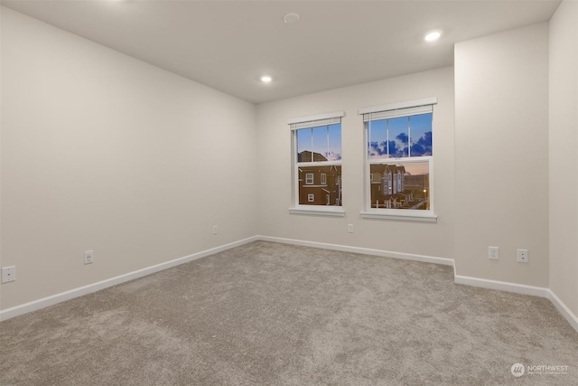 spare room with light colored carpet