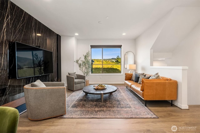 living area featuring recessed lighting, baseboards, and wood finished floors