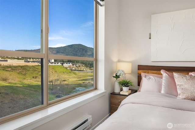 bedroom with a baseboard radiator and a mountain view